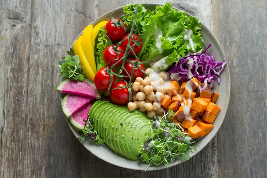 A colorful bowl of avocado, tomatoes, chickpeas and greens