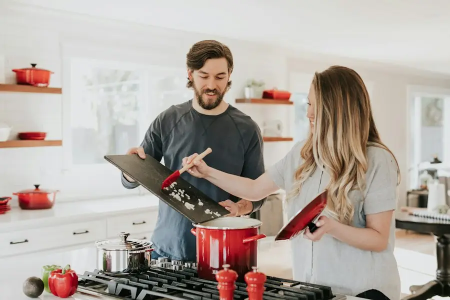 Two people cooking together in a bright kitchen
